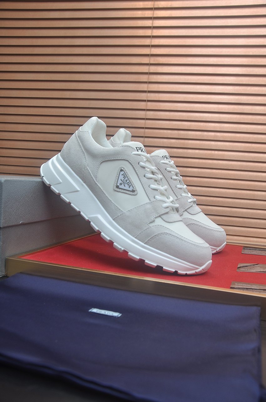 Prada Triangle Plaque Low-Top Sneakers — hero